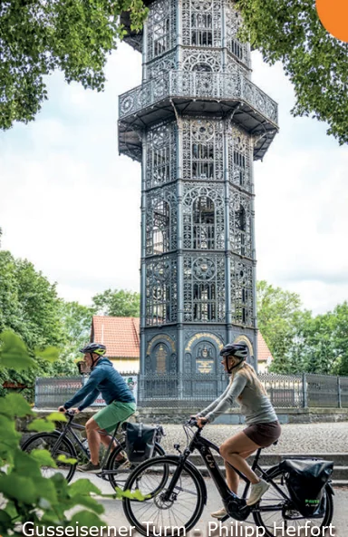 Radfahrer vor dem gusseisernen Turm in Löbau